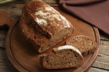 Pieces of fresh rye bread on wooden table, closeup