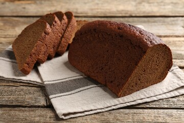 Pieces of fresh rye bread on wooden table, closeup