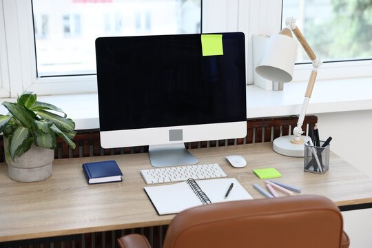 Stylish workplace with modern computer on wooden desk
