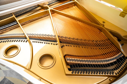 Detail of the inside grand piano, strings closeup, gavel of the string open mechanism.