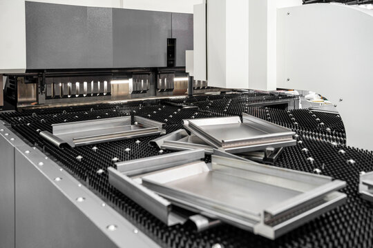 Automatic metal sheet bending machine at work in factory. CNC Panel Bender (Press Arm Type)