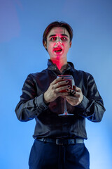 young guy with skull makeup celebrating a Halloween party