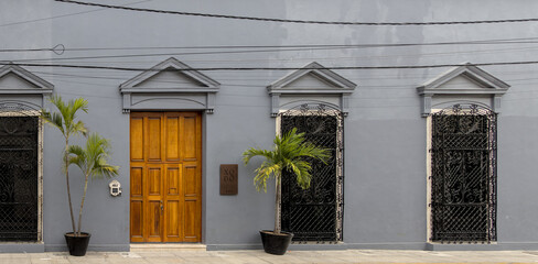 Beautiful colorful Spanish style colonial buildings housing businesses in Merida Yucatan Mexico.