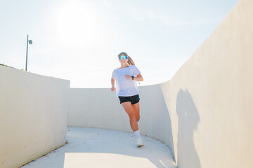Runner in motion along a stylish curved path during bright daylight
