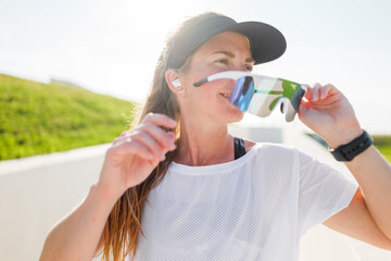 Active woman enjoying outdoor workout with stylish sunglasses