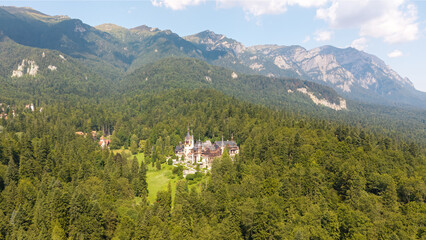 Aerial drone view of the beautiful Peles Castle in Sinaia, Transylvania, Romania, during the summer season.