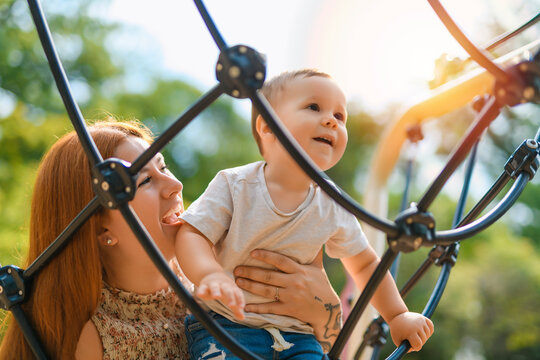 mother with child boy having fun at the playground
