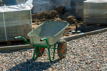 Green Wheelbarrow with Concrete at Construction