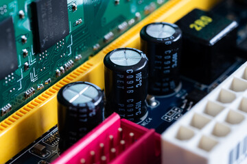 Capacitors or condensers in row on motherboard close up, electronic components