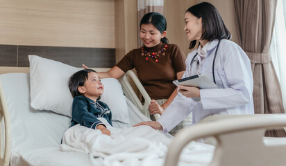 Caring Asian Female Doctor with Child Patient and Mother