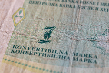 Close up of banknote money of Bosnian convertible mark, uncirculated bill of one mark, old and wear