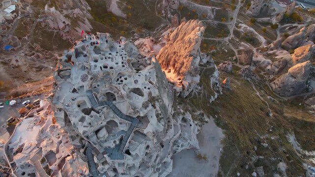 Aerial evening view Ancient Uchisar castle, underground city of Cappadocia Turkey, Goreme national park.