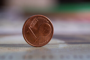 Close up of euro cent coin standing on edge, one cent value on front, fiat money