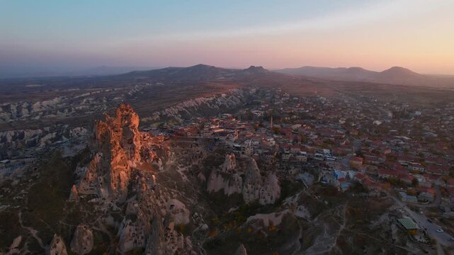 Aerial evening view Ancient Uchisar castle, underground city of Cappadocia Turkey, Goreme national park.