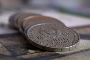 Close up of Soviet Union commemorative coin with coat of arms on obverse, uncirculated coin with dents and corrosion
