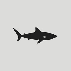 A minimalist black silhouette of a shark in profile, isolated on a plain gray background.