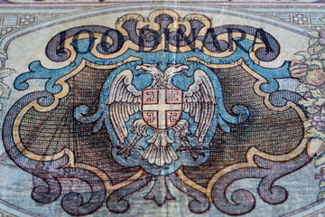 Serbian coat of arms on reverse of 100 dinar banknote, uncirculated money detail