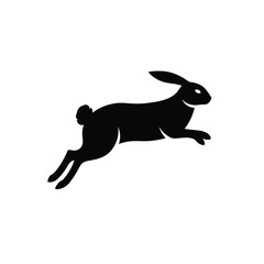 Black silhouette of a rabbit leaping forward with its ears perked up against a white background.