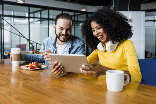 hispanic people coworkers eating and having a break at office in Mexico Latin America, Latin teamwork having a lunch time at job - Powered by Adobe