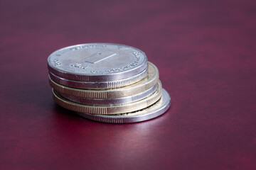 Stack of coins close up with one Bosnian mark on top, circulated money