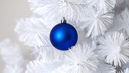 Blue Christmas ornament on a white tree