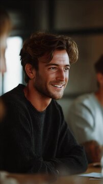Young man smiling at camera, relaxed atmosphere