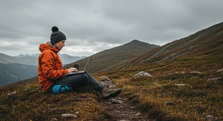 Person working on laptop in mountains