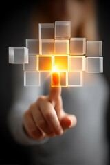 A hand pressing a glowing cube, representing innovation and interaction in technology. The design symbolizes modern digital advancements and connectivity.