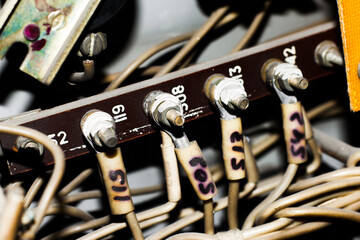 Close-up of old labeled electrical wires in a distribution box. Technical detail for industrial, engineering, or maintenance-related concepts