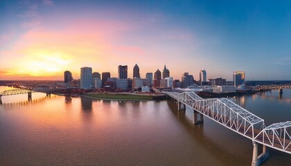 aerial shot of the skyline of louisville and the bridge at sunrise