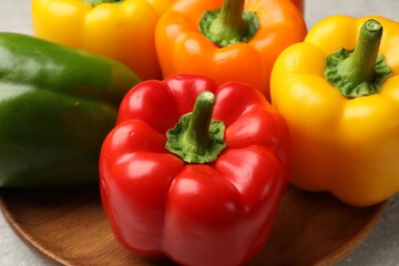 Fresh colorful bell peppers on table, closeup