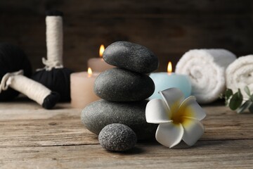 Composition with spa stones on wooden table, closeup