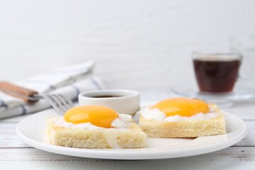 Tasty kaya toasts with half-boiled eggs served on white wooden table, closeup. Traditional asian...