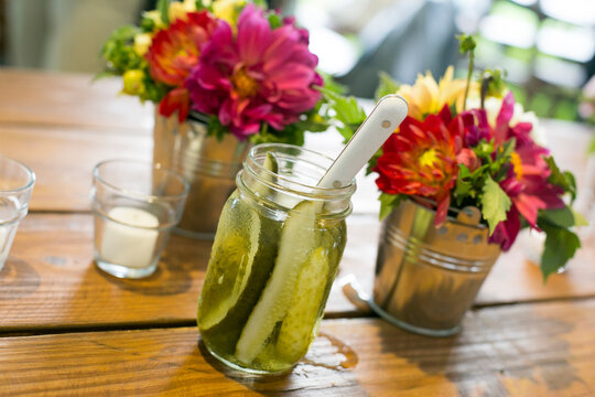 Fototapeta Kent, Connecticut, USA. Summer time jars of pickles and flowers on the picnic table.