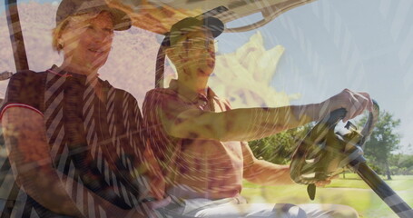 Riding senior couple wearing golf attire cruising fairway in golf cart, with steering wheel view