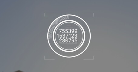 Showing digital circular interface with progress arc, readouts and corner markers on grey backdrop