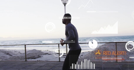Running man sporting fitted athletic gear on waterfront path, with metal railing ocean data overlay