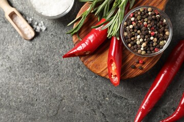 Different aromatic spices on grey table, flat lay. Space for text