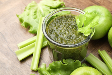 Superfood. Tasty smoothie in glass and ingredients on wooden table, closeup