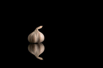 Garlic heads isolated on white and black background, close-up.