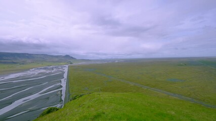 Pan across the scenic river plains of South Coast Iceland, filmed on June 11, 2025, showcasing summer landscape with a left to right pan.