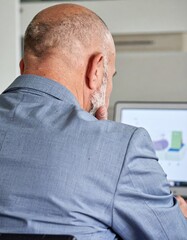 Fototapeta premium Concentrated Boss at Desk with Laptop