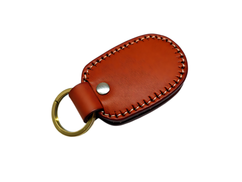 Orange leather car key fob cover with metal ring isolated on transparent background