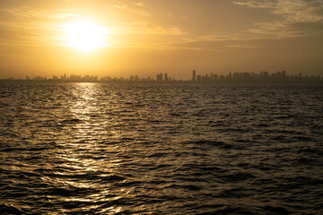 Belém city skyline buildings and Amazon River on a sunny summer day during sunset. Concept of environment, ecology, biodiversity, climate change, global warming, travel, tourism.
