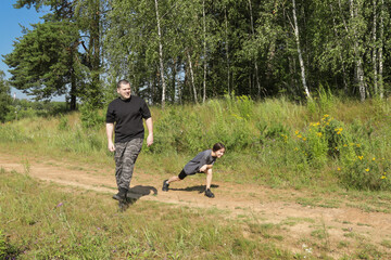 Active family lifestyle in nature: girl performing shoulder stretch and man doing high knees, illustrating multigenerational commitment to exercise and health.