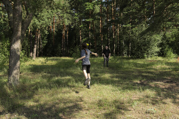 Father tossing frisbee to daughter in wide open meadow, joyful moment in nature highlighting active parenting, wholesome recreation, and physical engagement.