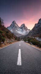 Fototapeta premium Snow-capped peaks of the Himalayas at sunrise with fog-covered road leading to Mount Everest and vibrant purple sky
