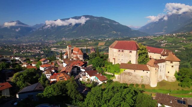Italy South Tyrol Aerial 4K Video Drone Orbit Flight Around Medieval Schenna Castle Traditional Village Vineyards and Majestic Alps Mountains Landscape Trentino-Alto Adige Travel