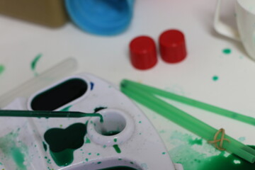 Children's hands playing with paints and colors at school