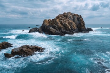 Dramatic ocean waves crash against rugged coastal sea stacks under a moody sky